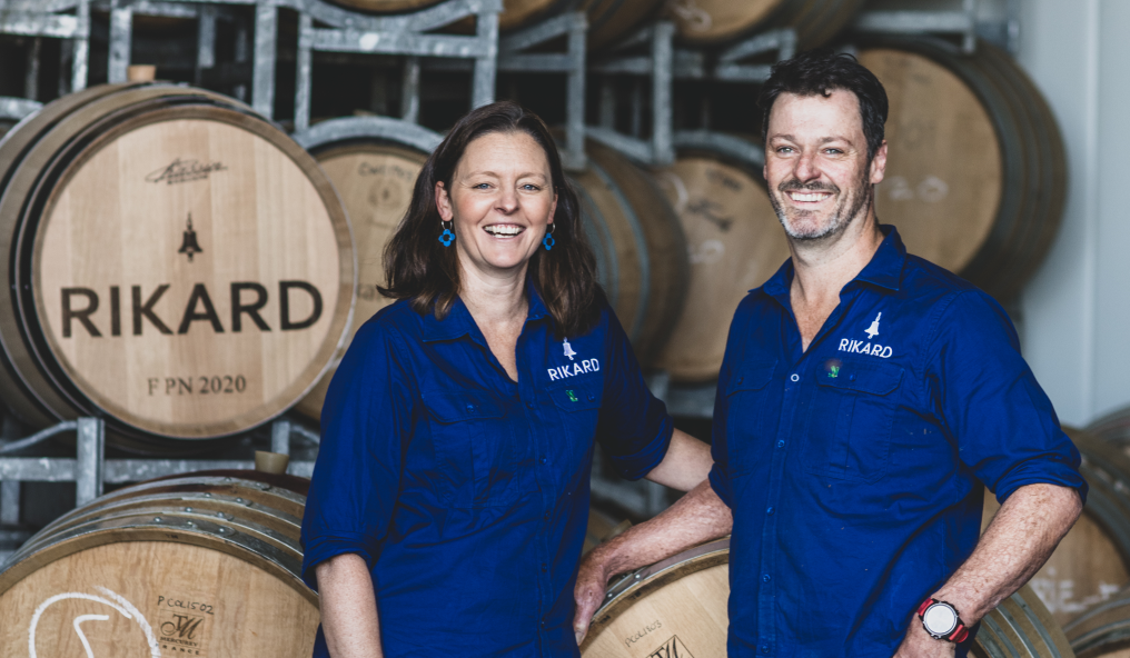 Smiling Rikard owners standing in barrel room